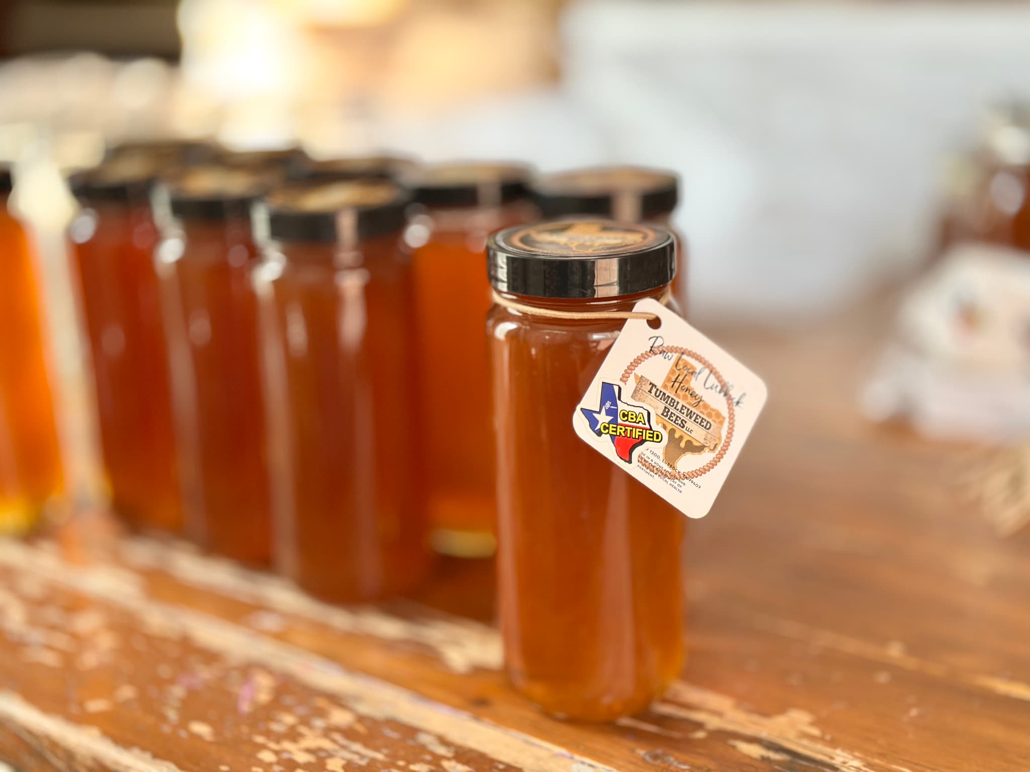 Jars of honey with a visible label on a wooden surface